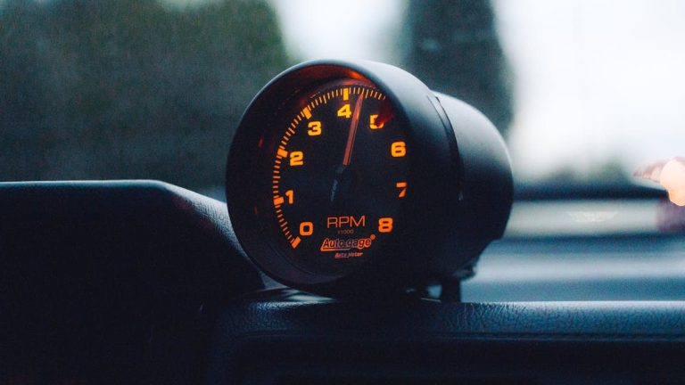 A glowing RPM gauge mounted on a car dashboard, emphasizing speed and automotive focus.